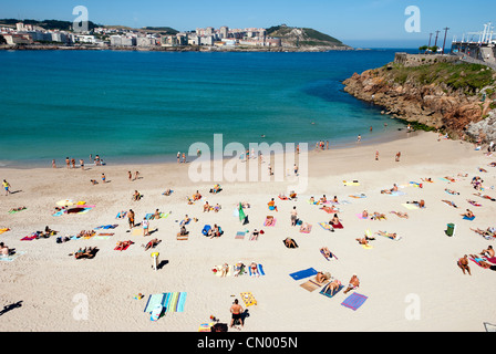 people sun bathing at playa de Orzan beach - Coruna, Galicia - Spain Stock Photo