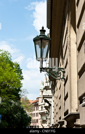 An unlit lamp post on the side of a building in the capital city of Prague, Czech Republic. Stock Photo
