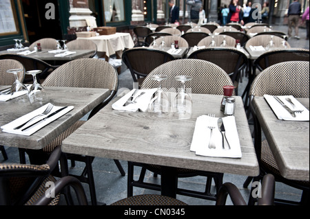 A closeup of neatly arranged tables in an empty Brussels Cafe. Stock Photo