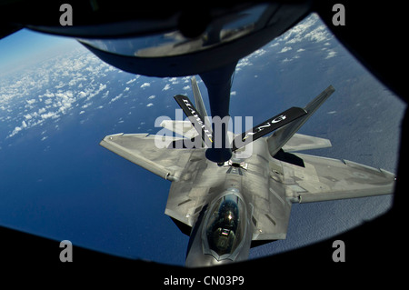 A Hawaii Air National Guard F-22 Raptor from the 199th Fighter Squadron, Joint Base Pearl Harbor-Hickam, Hawaii moves into position to take on fuel from a 96th Air Refueling Squadron KC-135 Stratotanker on March 27, 2012, during a recent mission over the Pacific near the Hawaiian Islands. During this refueling mission Air Force Academy Cadets on spring break received a familiarization flight to give the cadets a better understanding of the Air Force’s global reach capabilities. Stock Photo
