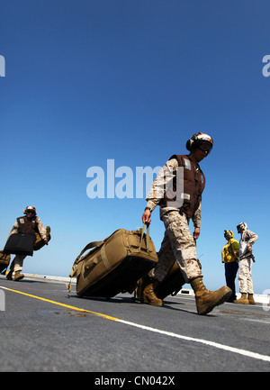 Marines and sailors with the 24th Marine Expeditionary Unit and Iwo Jima Amphibious Ready Group load equipment and supplies onto the USS New York, March 29, 2012, before embarking upon a scheduled eight-month deployment. The 24th MEU, partnered with the Navy's Iwo Jima ARG, is deploying to the European and Central Command theaters of operation to serve as a theater reserve and crisis response force capable of a variety of missions from full-scale combat operations to humanitarian assistance and disaster relief. Stock Photo