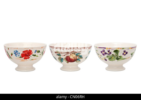 Glazed earthenware bowls with hand-applied patterns. Bols en faïence émaillée avec motifs appliqués à la main. Stock Photo