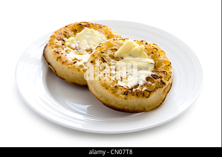 hot toasted crumpets with butter on a white background Stock Photo