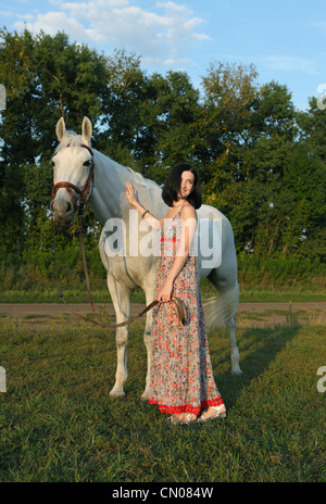 The young white girl posing with arabian horse Stock Photo