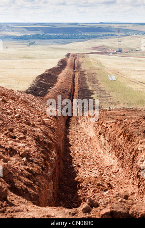 The trench for laying oil pipes in the oil field in Russia Stock Photo