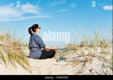 Woman practicing yoga at the beach, Cape Cod. Stock Photo