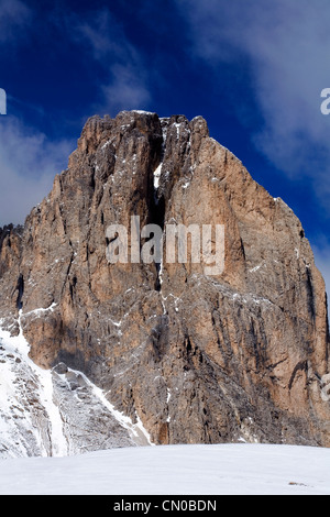 The Sun catching a rock face on The Sassolungo Langkofel towering above The Val Gardena Selva  Dolomites Italy Stock Photo