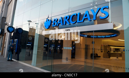 Exterior view of new Barclays Bank branch & person getting cash money at ATM at The Hayes Cardiff Wales UK   KATHY DEWITT Stock Photo