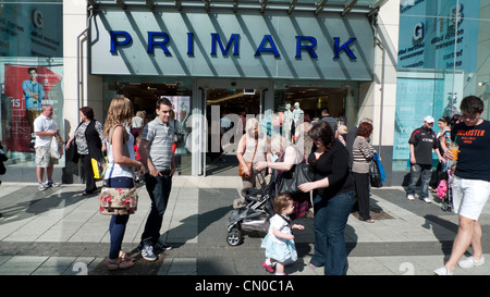 Shoppers outside Primark storefront store on Queen Street Cardiff Wales UK  KATHY DEWITT Stock Photo