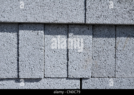 Close detail of stacked concrete building blocks on construction site. Metaphor UK construction industry, construction supplies, building materials. Stock Photo