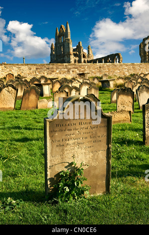 Cemetery headstone with Whitby Abbey behind, Whitby, North Yorkshire, England Stock Photo