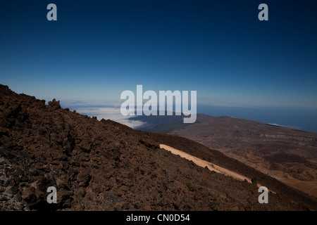 View of the landscape to the eastern side of Mt Teide, showing debris from lava flow and blue sky Stock Photo