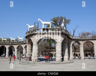 Visitors with children relaxing in the rock gardens at Chandigarh in Punjab India Stock Photo