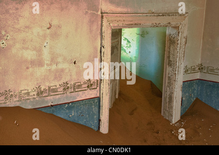 Interior room in Kolmanskop, a ghost mining town in Namibia, Africa. The desert has reclaimed the town after it was abandoned.