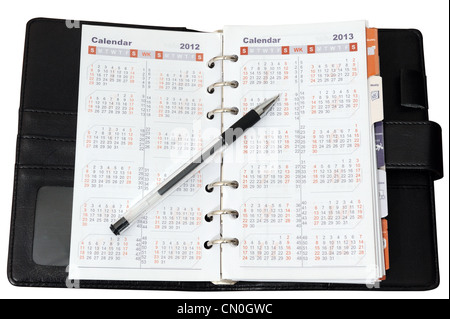 Calendar in notebook with a pen on it Stock Photo