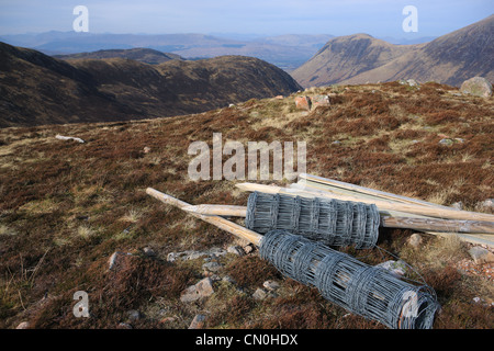 Rolls of stock fencing on a hillside in the Nevis range of mountains in Scotland Stock Photo