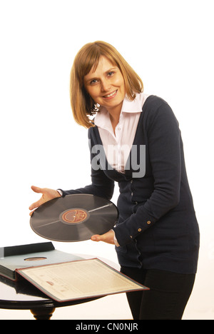 Woman presents old gramophone plate Stock Photo