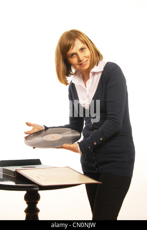 Woman presents old gramophone plate Stock Photo