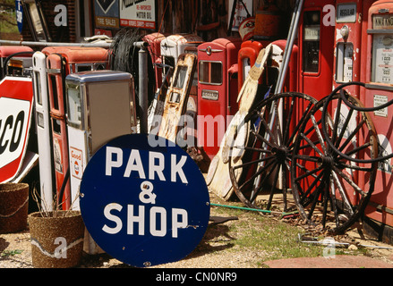 Junkyard of old signs ans gas pumps Stock Photo