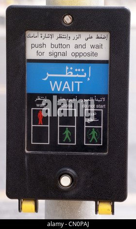 Pelican crossing control button, with Arabic script, Dubai, United Arab Emirates Stock Photo