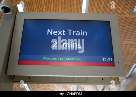 Station announcement  screen 'next train 2 minutes' Burj Khalifa Metro station, Dubai, United Arab Emirates Stock Photo