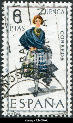 SPAIN - CIRCA 1968: A stamp printed in Spain, shows a woman in folk dress of the region Cuenca, circa 1968 Stock Photo