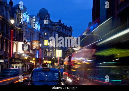 London Theatreland Lyric, Apollo and Gielgud Theatres Shaftesbury Avenue at night with traffic trails London England UK Stock Photo