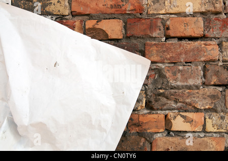 Blank torn paper poster on an old brick wall Stock Photo