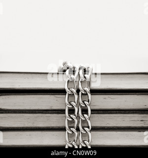 Censorship concept with tattered books and chains on white Stock Photo
