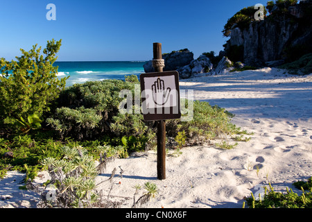 Brown and tan sign showing a hand pictogram at a beautiful Caribbean beach (landscape format) Stock Photo