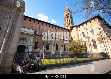 men playing musical instruments at the gates outside The Basilica of St. Sernin, in Toulouse, Midi Pyrenees, France Stock Photo