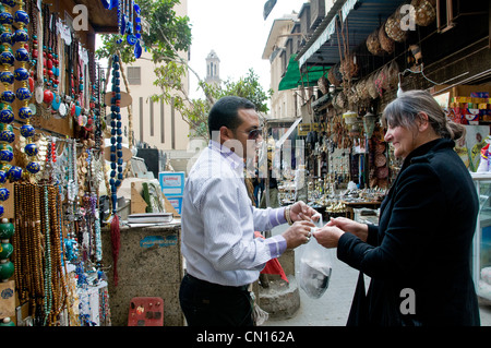 Foreign tourist buying souvenirs from Shopkeeper in Khan El Khalili Cairo Egypt Stock Photo