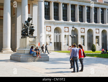 Madrid, Spain. Visitors taking pictures in front of statue of Spanish artist Diego Velazquez outside the El Prado museum. Stock Photo