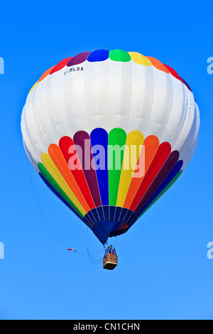 Hot air balloon drifting on a calm sunny afternoon, Italy Stock Photo