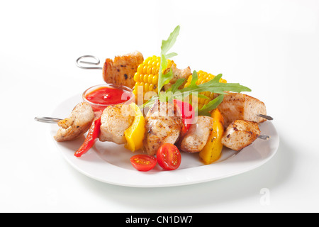 Grilled meat and vegetable on skewers and ketchup Stock Photo