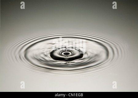 Drop of Water Creating Ripples Stock Photo