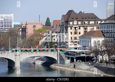 Mittlere bridge over the river Rhine with green tram traveling across. Basel, Switzerland. Stock Photo