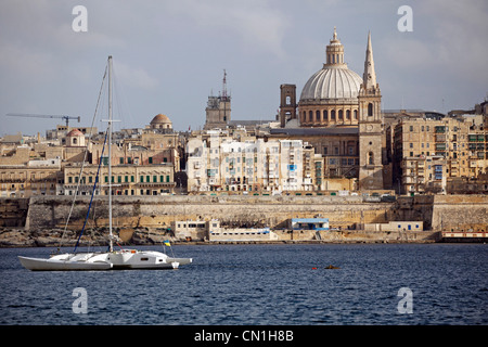 The spire of St. Paul's Anglican Pro-Cathedral and the Carmelite Church dome on the city skyline of Valletta, Malta Stock Photo