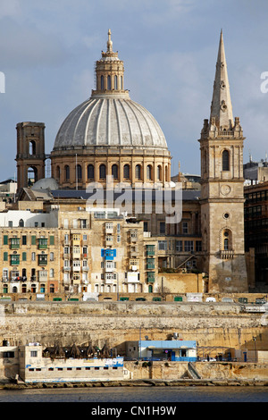 The spire of St. Paul's Anglican Pro-Cathedral and the Carmelite Church dome on the city skyline of Valletta, Malta Stock Photo