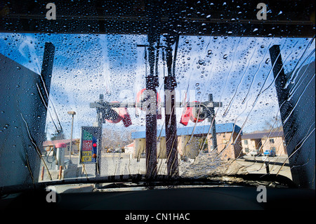 View through the windshield of an automobile in an automated car wash. Stock Photo