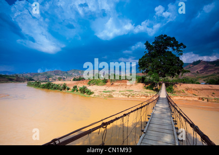 Footbridge over river, North Central Highlands, Vietnam Stock Photo