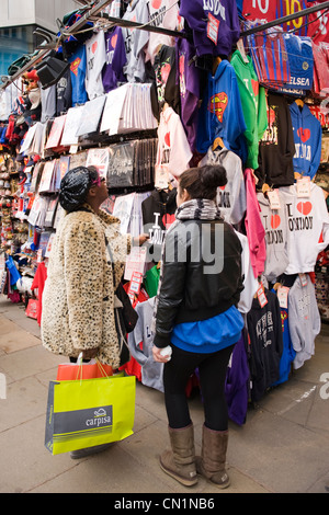 Oxford Street London West End shoppers admire typical souvenir clothes sweat shirt tee t shirt hoodies stall I Love London Stock Photo