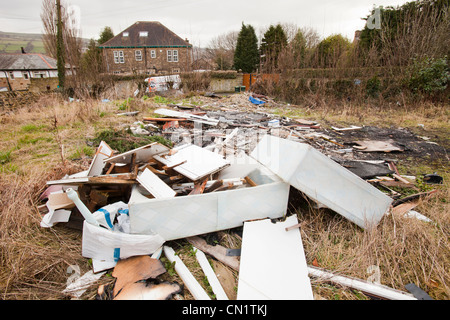 Rubbish dumped on waste ground in Keighley, West Yorkshire, UK. Stock Photo