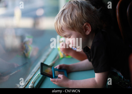 Child Playing Nintendo Gameboy Stock Photo