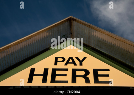 Yellow Payment Sign against Blue Sky Background