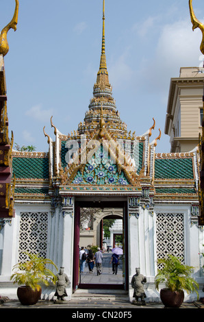 Thailand, Bangkok. The Grand Palace, established in 1782. Tourists walking through temple gates. Stock Photo