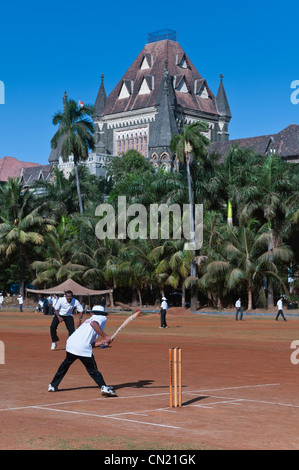 Playing cricket Oval Maidan High Court building Mumbai Bombay India Stock Photo