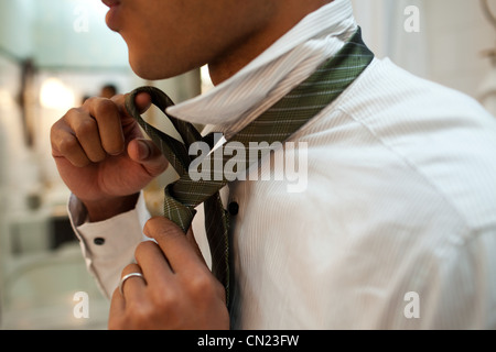 Man putting on tie Stock Photo