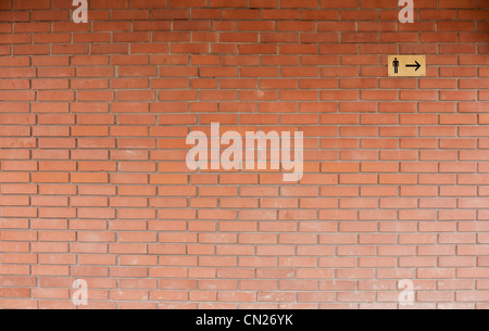 Male toilet sign on brick wall Stock Photo