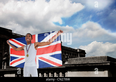 Olympic gold medal winner with Union Jack Stock Photo